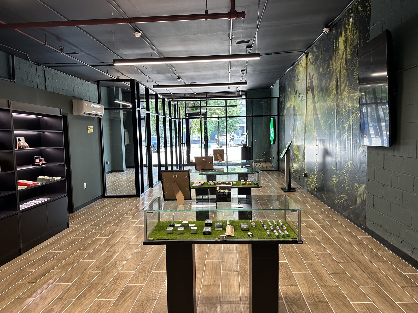 Wide interior view of Jungle Kingdom Flower East Williamsburg with natural light from glass storefront